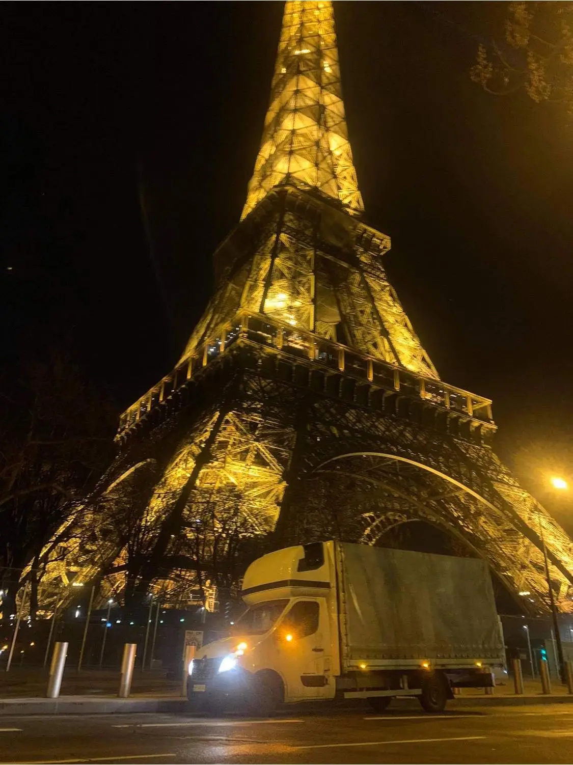 Samochód dostawczy stojący pod Wieżą Eiffla
